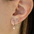 The Land of Salt Star and Moon Huggie Hoops in Silver